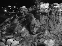 a pile of rocks on a street at night
